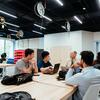 A Temple professor meets with a group of students in an engineering lab.