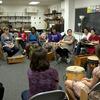 Music Therapy Jazz students sit in a circle in a classroom with different kinds of percussion instruments in front of them.